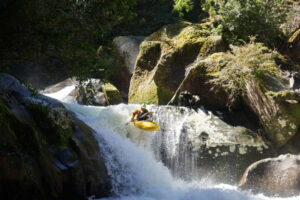 Kayaking during Pucon Creek Week with a Waterfall Boof