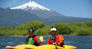 Kayaking Trancura River in Chile with view of Villarrica Volcano